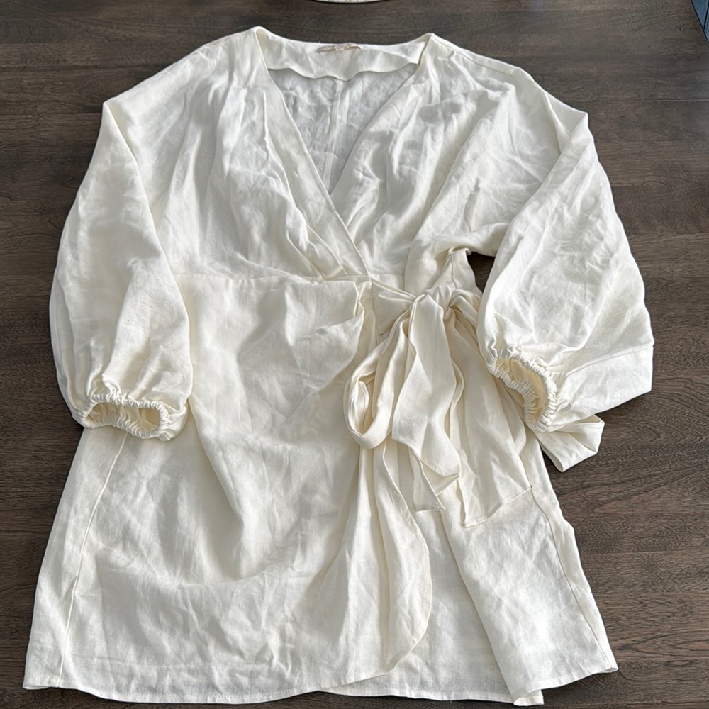 Cream colored quarter sleeve wrap dress